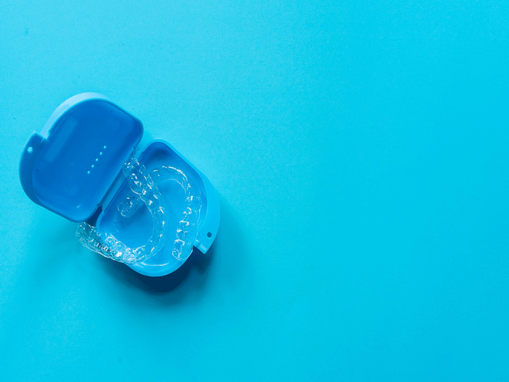 image of a dental retainer in a blue case on a blue background
