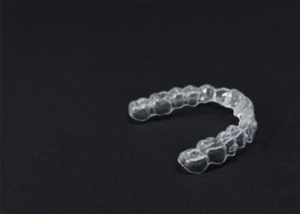 Image of a dental retainer on black background